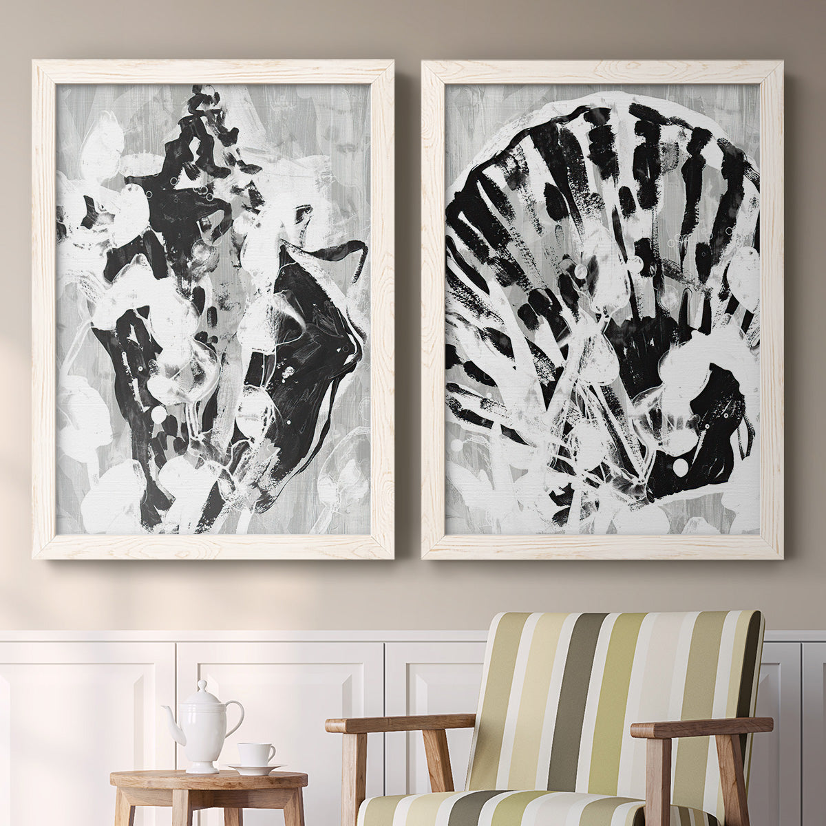 Set of two white barnwood framed canvas prints depicting two dramatic monochrome abstracts featuring black and gray inkblot bursts above a sideboard in a cozy sitting room.
