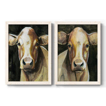 Set of two white barnwood framed canvas prints featuring two painterly farm-animal portraits featuring close-up portraits of gentle brown cows.