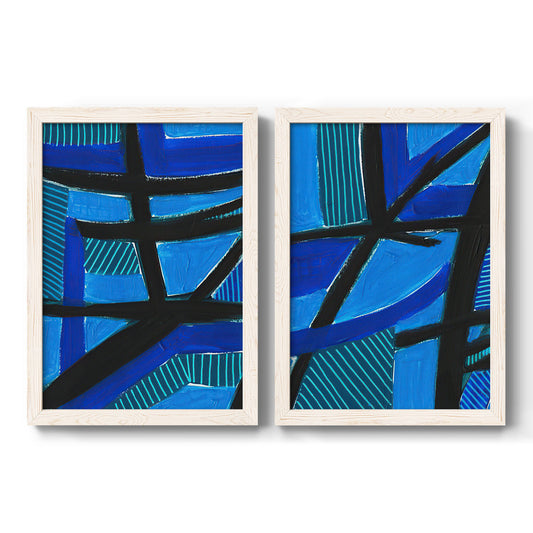 Set of two white barnwood framed canvas prints featuring two bold geometric abstracts featuring intersecting black bars over vivid blue fields.