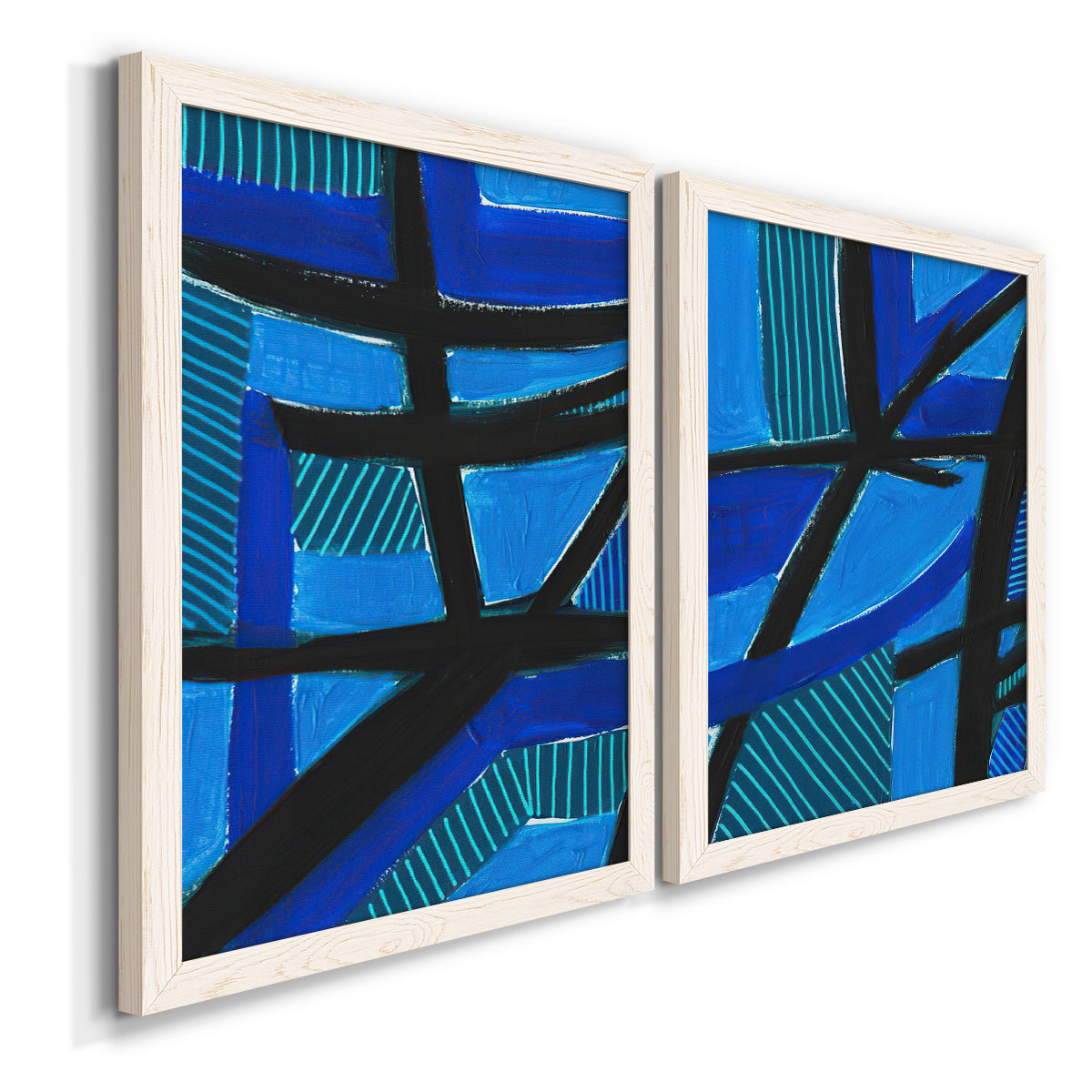 Angled view of a set of two white barnwood framed canvas prints featuring two bold geometric abstracts featuring intersecting black bars over vivid blue fields.