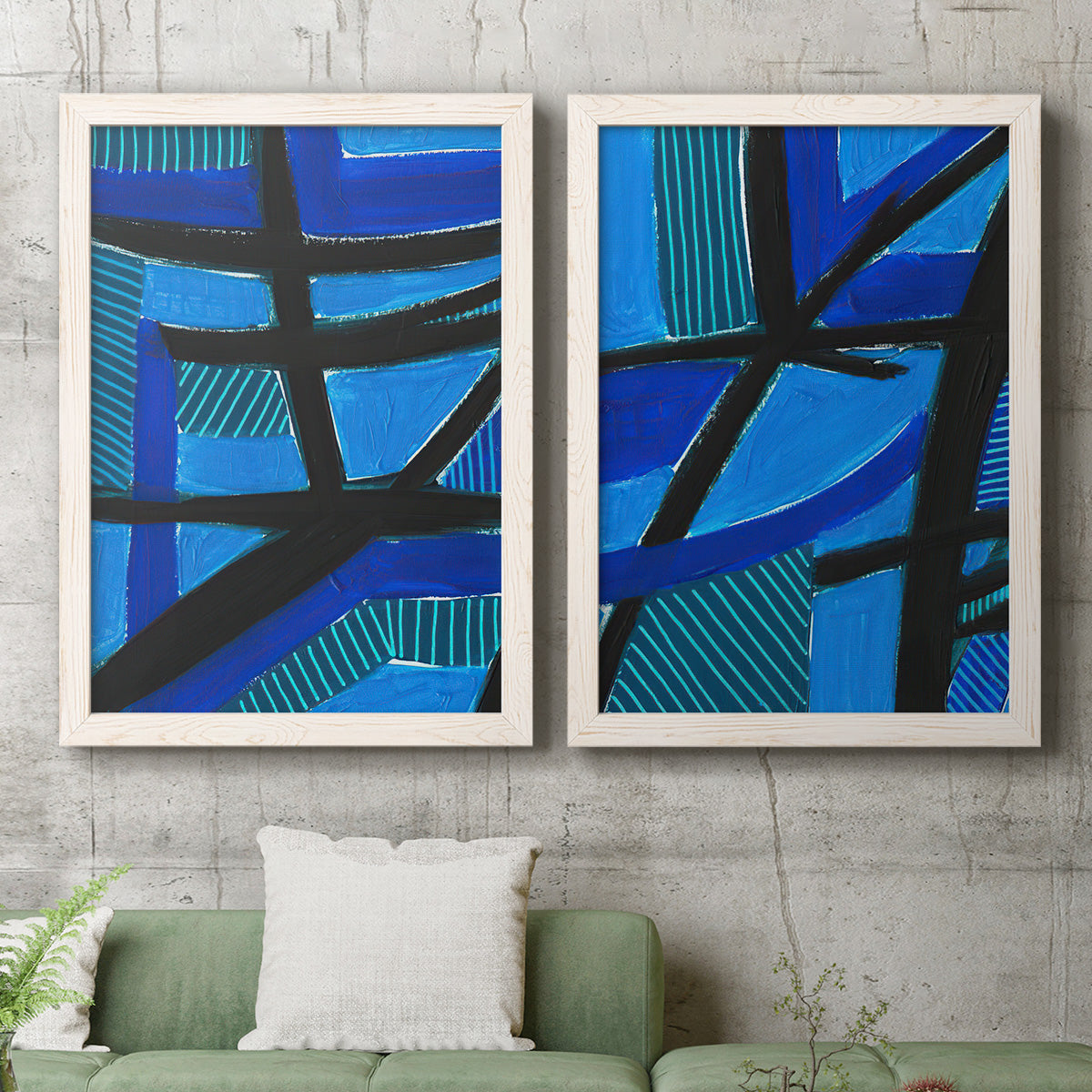 Set of two white barnwood framed canvas prints depicting a coordinated art pair of intersecting black bars over vivid blue fields rendered as bold geometric abstracts above a sofa in a modern living room.