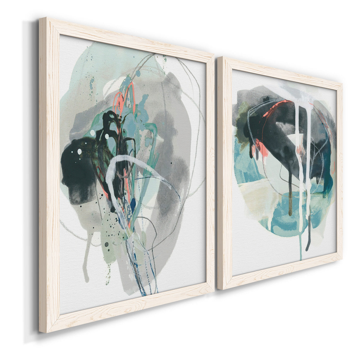 Angled view of a set of two white barnwood framed canvas prints featuring two bold gestural abstracts featuring large black gray and teal circular gestures.