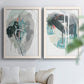 Set of two white barnwood framed canvas prints depicting looping ink forms, drips, pale washes, and coral accents arranged across two complementary compositions above a sofa in a bright living space.