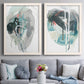 Set of two white barnwood framed canvas prints depicting paired bold gestural abstracts with looping ink forms, drips, pale washes, and coral accents above a sofa in a contemporary living room.