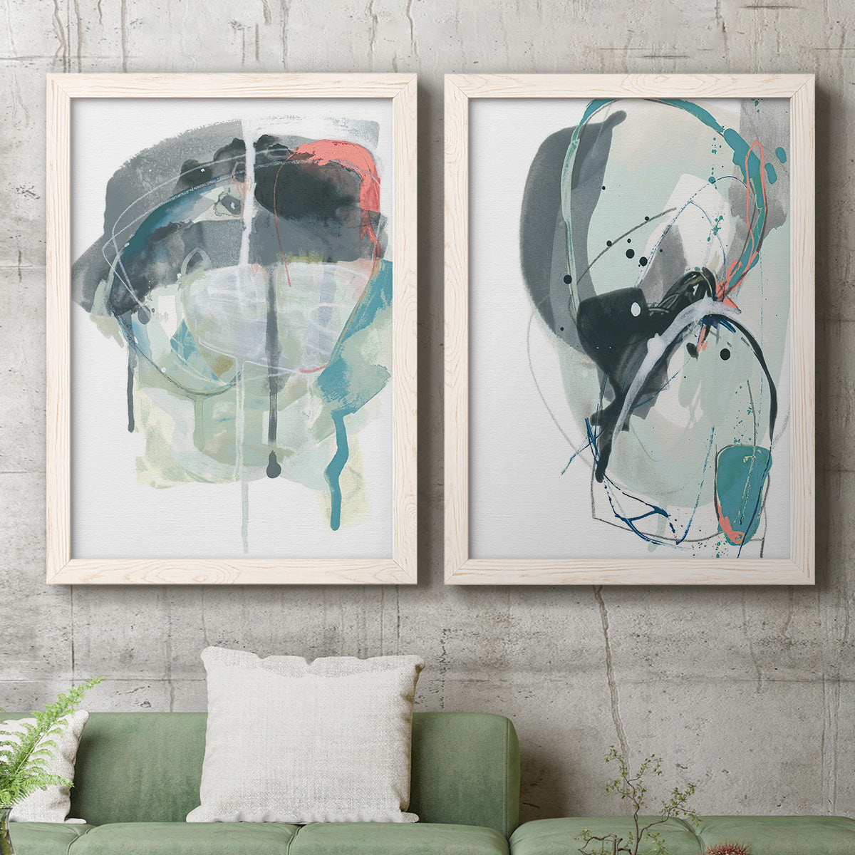 Set of two white barnwood framed canvas prints depicting a coordinated art pair of large black gray and teal circular gestures rendered as bold gestural abstracts above a sofa in a modern living room.