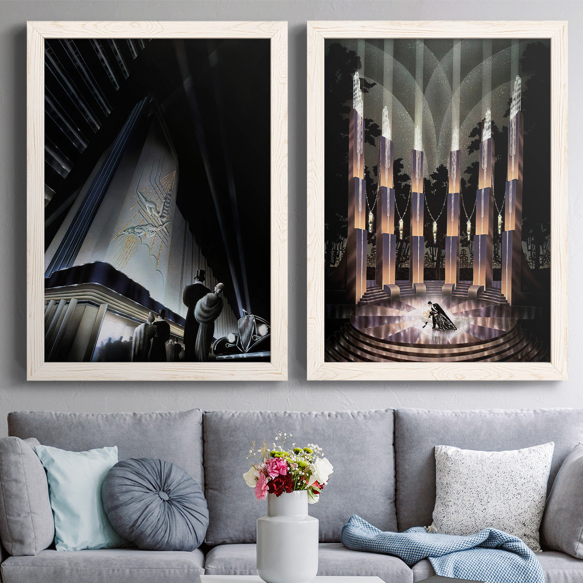 Set of two white barnwood framed canvas prints depicting paired vintage architectural illustrations with monumental skyscrapers, sweeping stairways, spotlights, and elegant nighttime figures above a sofa in a contemporary living room.