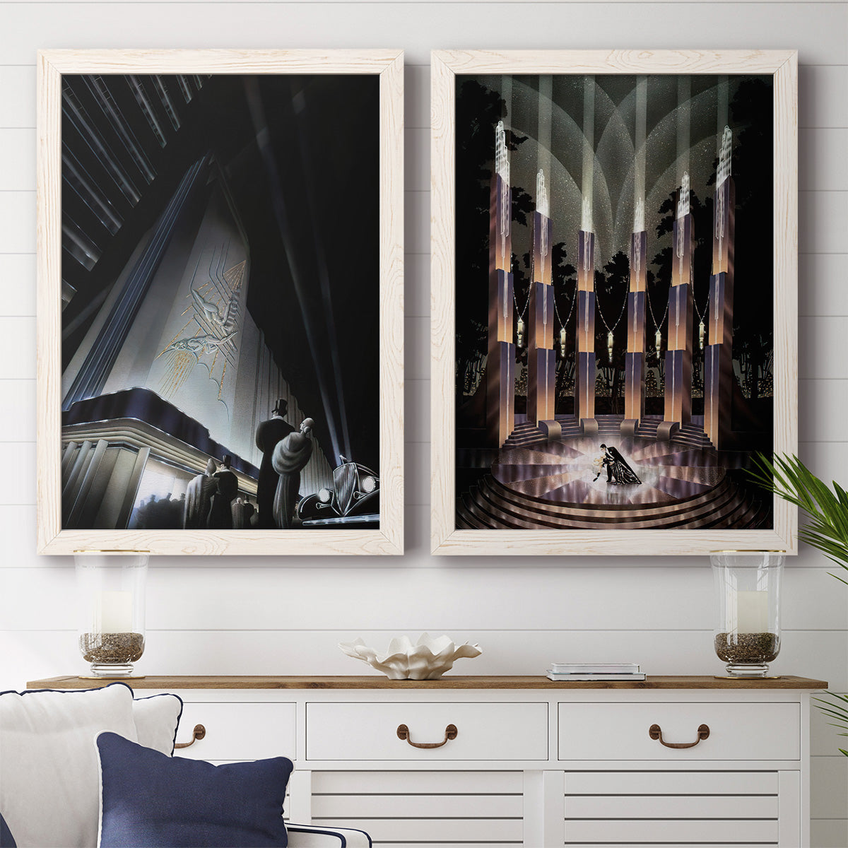 Set of two white barnwood framed canvas prints depicting a coordinated art pair of dramatic Art Deco city and theater scenes rendered as vintage architectural illustrations above a dining room sideboard.