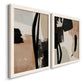 Angled view of a set of two white barnwood framed canvas prints featuring two minimalist collage-like abstracts featuring black taupe cream and beige painted forms.