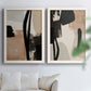 Set of two white barnwood framed canvas prints depicting bold brush arcs, blocky shapes, and spacious neutral grounds arranged across two complementary compositions above a sofa in a bright living space.