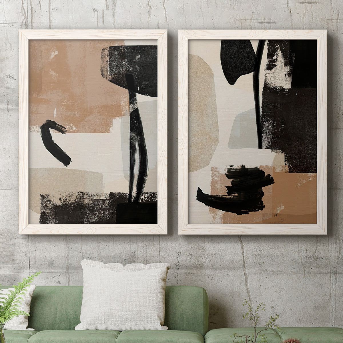 Set of two white barnwood framed canvas prints depicting a coordinated art pair of black taupe cream and beige painted forms rendered as minimalist collage-like abstracts above a sofa in a modern living room.