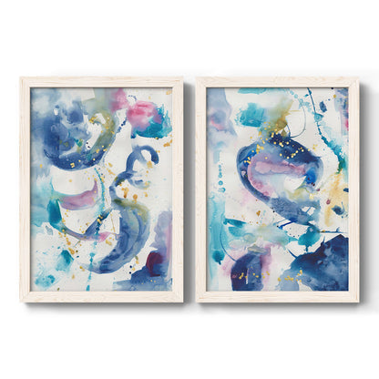 Set of two white barnwood framed canvas prints featuring two colorful lyrical abstracts featuring lively blue pink violet and turquoise watercolor gestures.