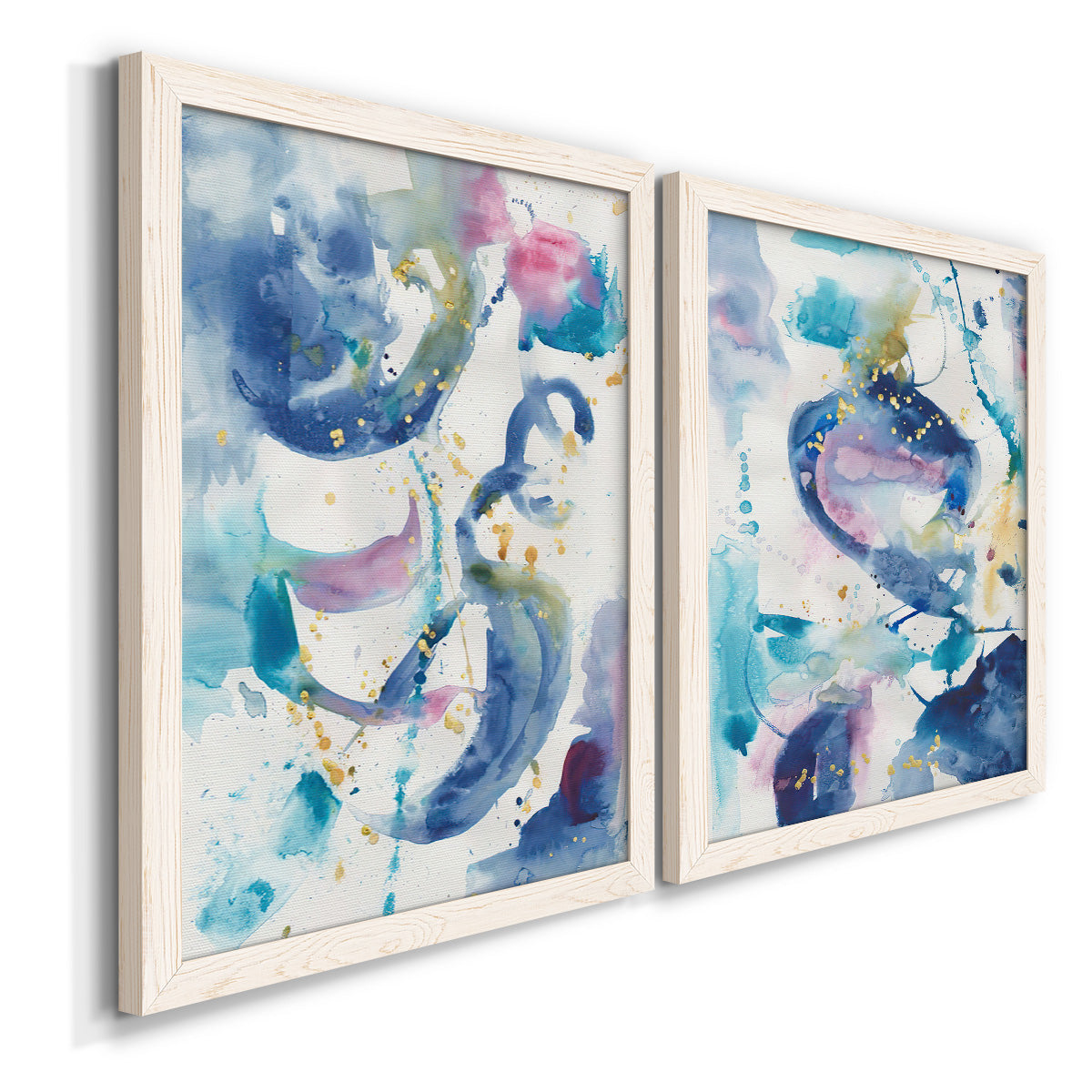 Angled view of a set of two white barnwood framed canvas prints featuring two colorful lyrical abstracts featuring lively blue pink violet and turquoise watercolor gestures.
