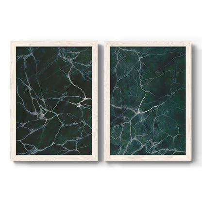 Set of two white barnwood framed canvas prints featuring two dramatic stone-inspired abstracts featuring dark green marble veining.