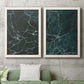 Set of two white barnwood framed canvas prints depicting a coordinated art pair of dark green marble veining rendered as dramatic stone-inspired abstracts above a sofa in a modern living room.