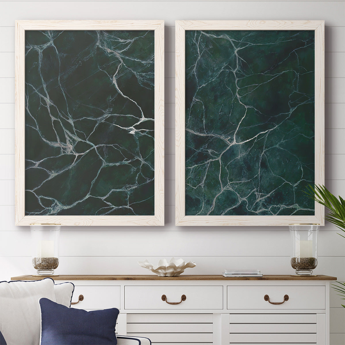 Set of two white barnwood framed canvas prints depicting a coordinated art pair of dark green marble veining rendered as dramatic stone-inspired abstracts above a dining room sideboard.