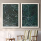 Set of two white barnwood framed canvas prints depicting two dramatic stone-inspired abstracts featuring dark green marble veining above a sideboard in a cozy sitting room.