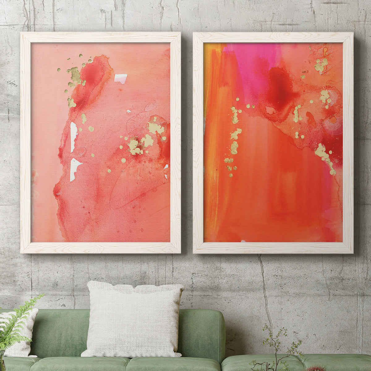 Set of two white barnwood framed canvas prints depicting a coordinated art pair of luminous coral orange and pink color fields with gold flecks rendered as glamorous fluid abstracts above a sofa in a modern living room.