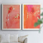 Set of two white barnwood framed canvas prints depicting translucent warm washes, drips, and scattered metallic accents arranged across two complementary compositions above a sofa in a bright living space.