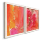 Angled view of a set of two white barnwood framed canvas prints featuring two glamorous fluid abstracts featuring luminous coral orange and pink color fields with gold flecks.