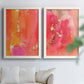 Set of two white barnwood framed canvas prints depicting translucent warm washes, drips, and scattered metallic accents arranged across two complementary compositions above a sofa in a bright living space.