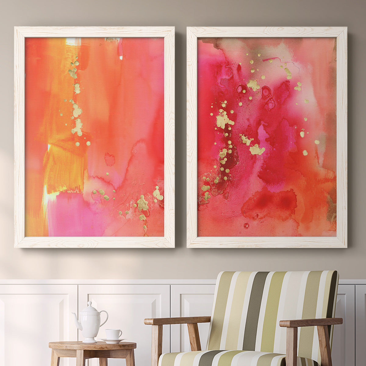 Set of two white barnwood framed canvas prints depicting two glamorous fluid abstracts featuring luminous coral orange and pink color fields with gold flecks above a sideboard in a cozy sitting room.