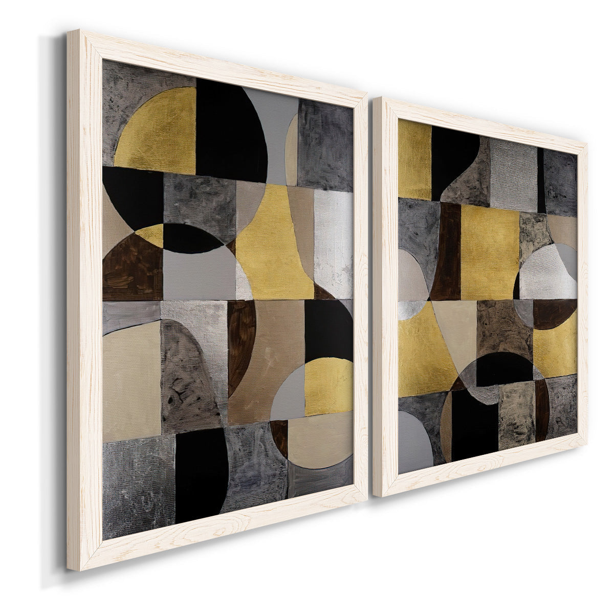 Angled view of a set of two white barnwood framed canvas prints featuring two structured modern abstracts featuring interlocking black gray cream and gold geometric sections.