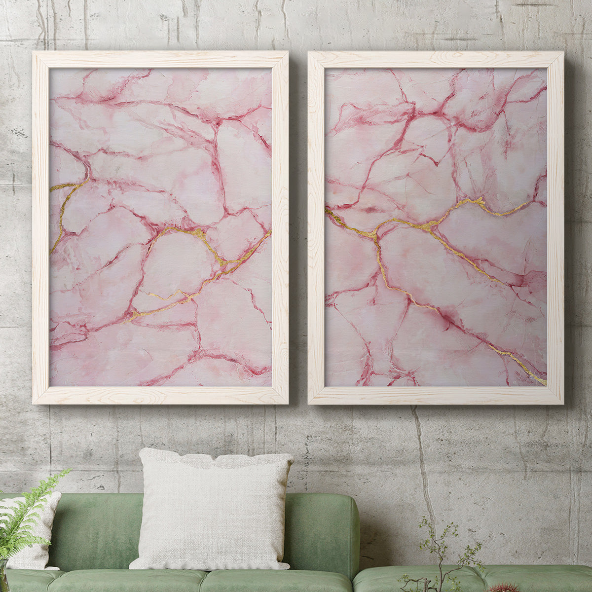 Set of two white barnwood framed canvas prints depicting a coordinated art pair of pink marble veining with fine gold lines rendered as soft stone-inspired abstracts above a sofa in a modern living room.