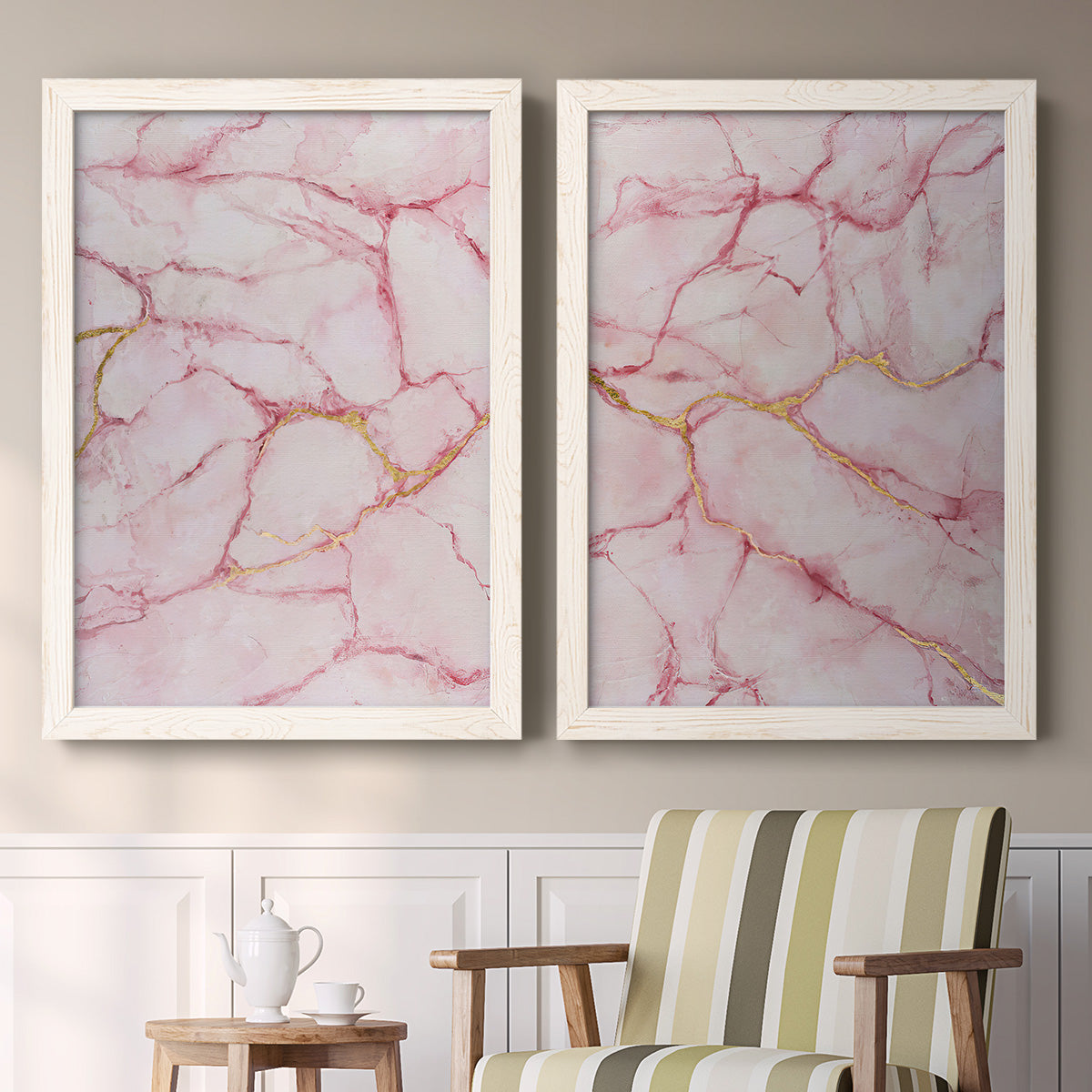 Set of two white barnwood framed canvas prints depicting two soft stone-inspired abstracts featuring pink marble veining with fine gold lines above a sideboard in a cozy sitting room.