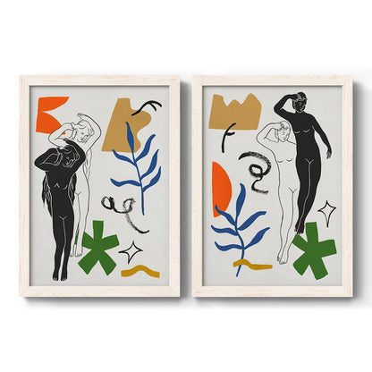 Set of two white barnwood framed canvas prints featuring two graphic figurative collages of women with bold botanical shapes stars and abstract symbols.