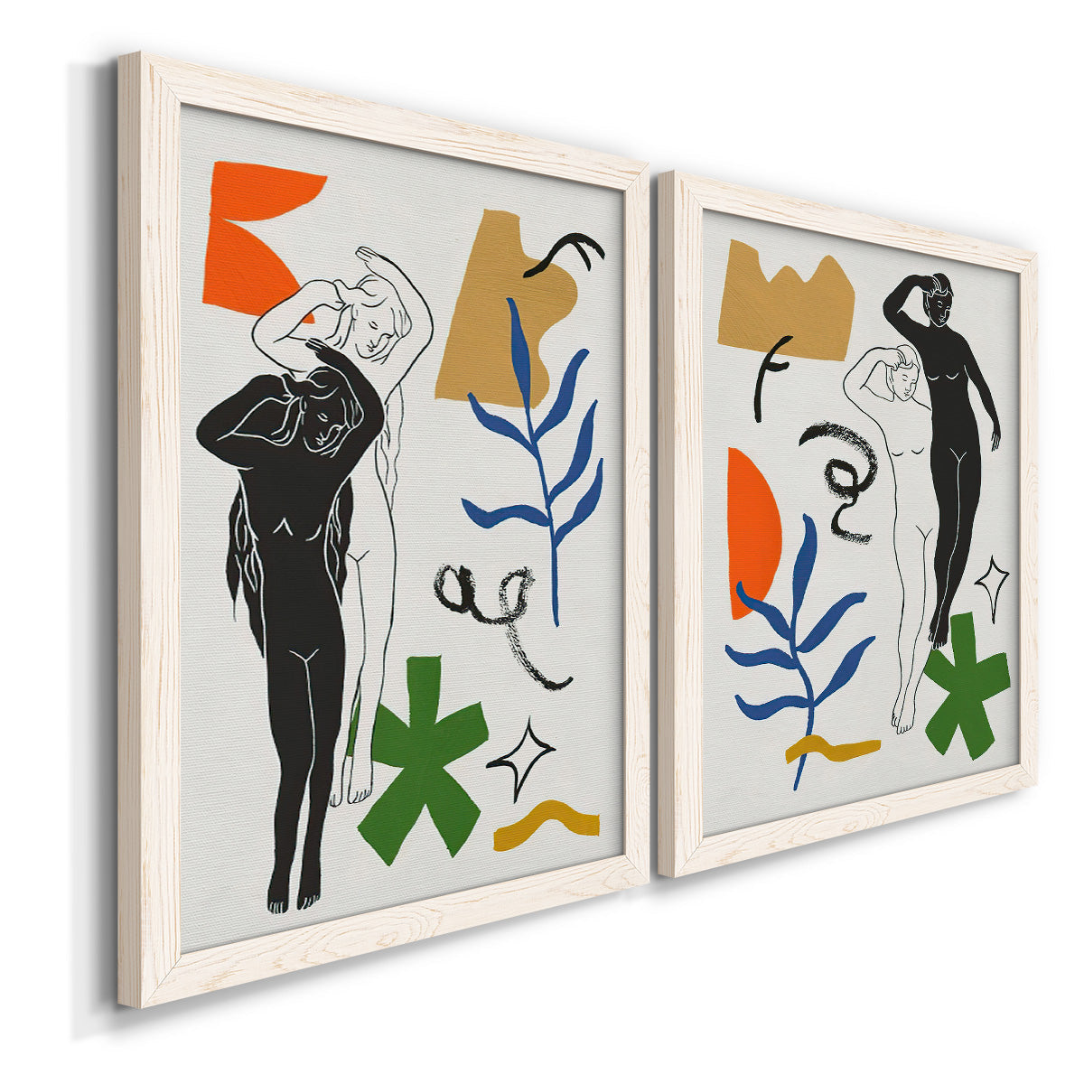 Angled view of a set of two white barnwood framed canvas prints featuring two graphic figurative collages of women with bold botanical shapes stars and abstract symbols.