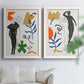 Set of two white barnwood framed canvas prints depicting a modern collage pair combining black and white women organic motifs and playful geometric accents above a sofa in a bright living space.