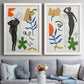 Set of two white barnwood framed canvas prints depicting expressive figure studies layered with colorful foliage celestial icons and hand drawn abstract shapes above a sofa in a contemporary living room.