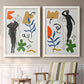 Set of two white barnwood framed canvas prints depicting two graphic figurative collages of women with bold botanical shapes stars and abstract symbols above a sideboard in a cozy sitting room.