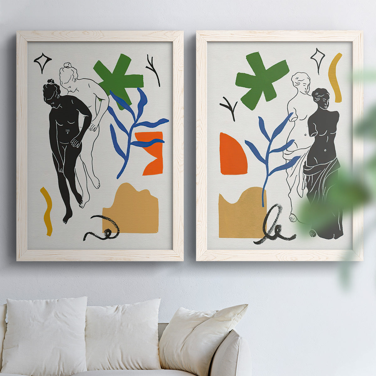 Set of two white barnwood framed canvas prints depicting black linework, bold green blue orange shapes, and classical statue poses arranged across two complementary compositions above a sofa in a bright living space.