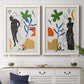 Set of two white barnwood framed canvas prints depicting a coordinated art pair of stylized female figures surrounded by botanical and geometric symbols rendered as graphic figurative collages above a dining room sideboard.