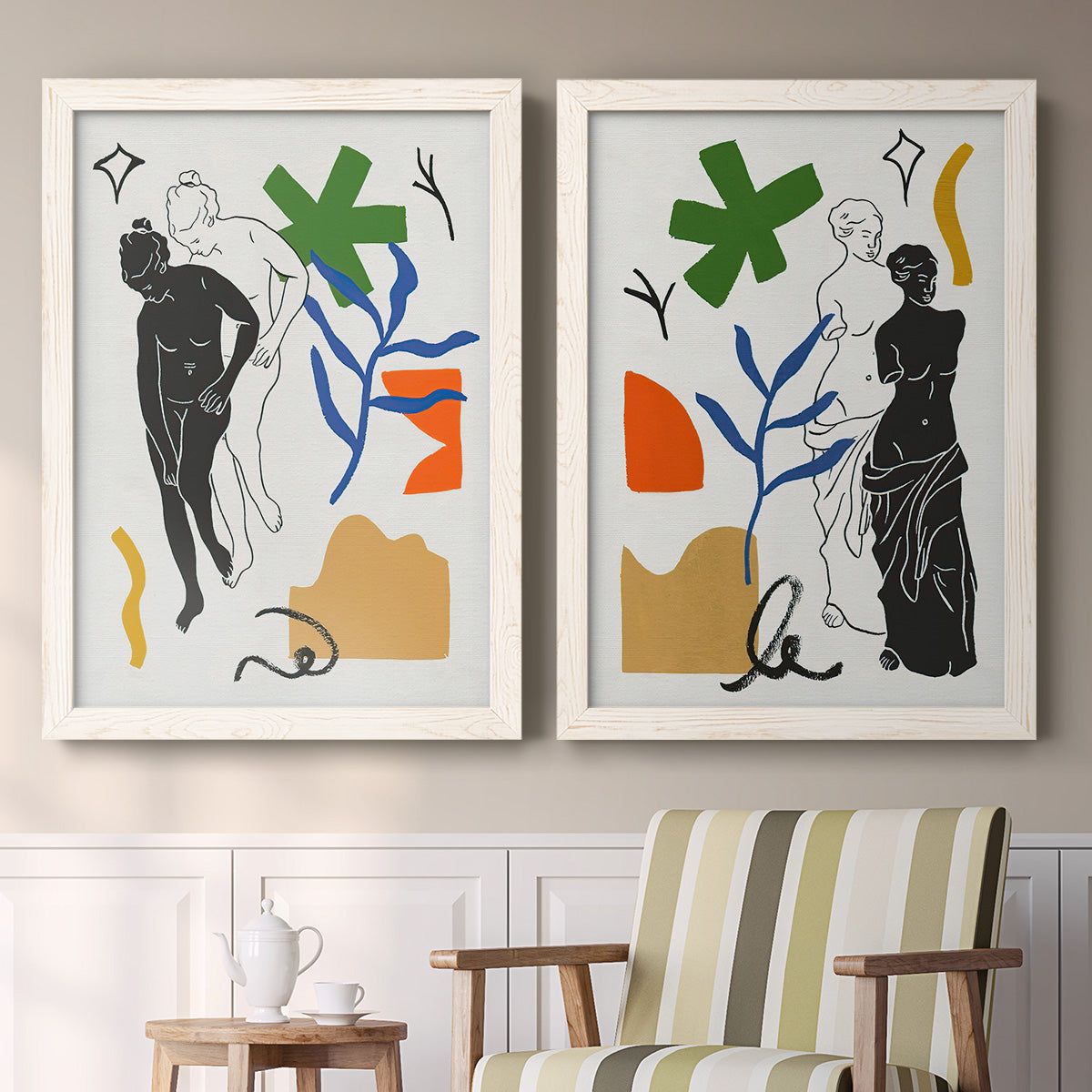 Set of two white barnwood framed canvas prints depicting two graphic figurative collages featuring stylized female figures surrounded by botanical and geometric symbols above a sideboard in a cozy sitting room.
