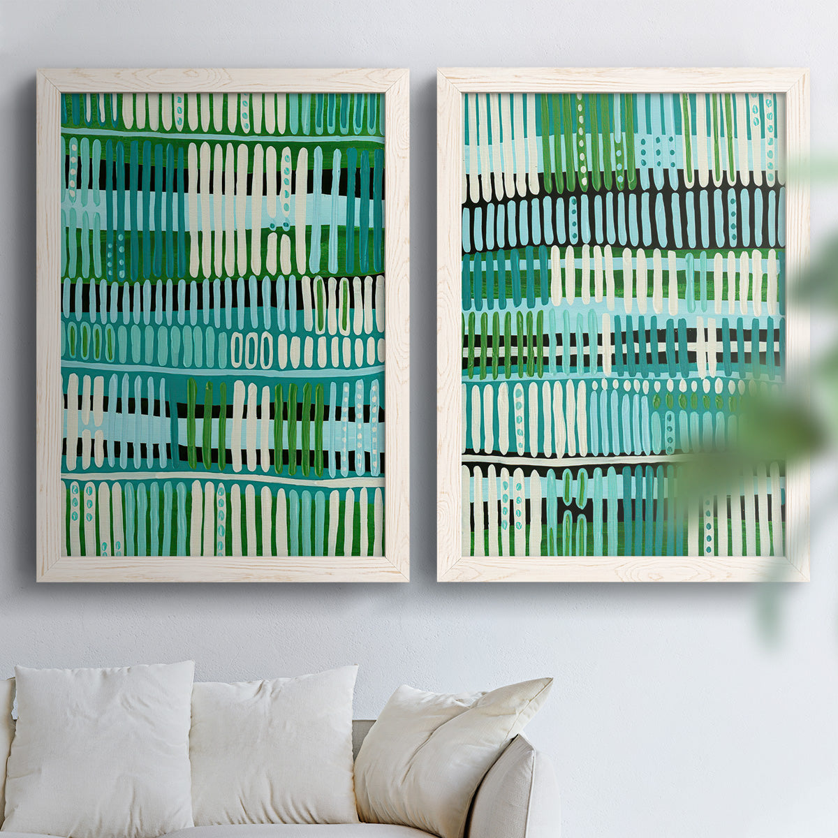 Set of two white barnwood framed canvas prints depicting repeating vertical dashes, grid rhythms, and textile-like structure arranged across two complementary compositions above a sofa in a bright living space.