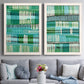 Set of two white barnwood framed canvas prints depicting paired graphic woven-pattern abstracts with repeating vertical dashes, grid rhythms, and textile-like structure above a sofa in a contemporary living room.