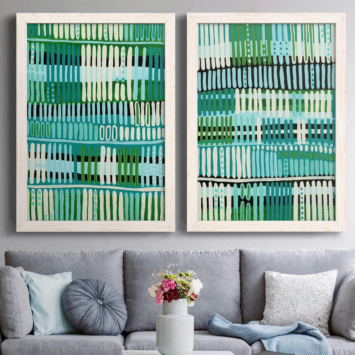 Set of two white barnwood framed canvas prints depicting paired graphic woven-pattern abstracts with repeating vertical dashes, grid rhythms, and textile-like structure above a sofa in a contemporary living room.