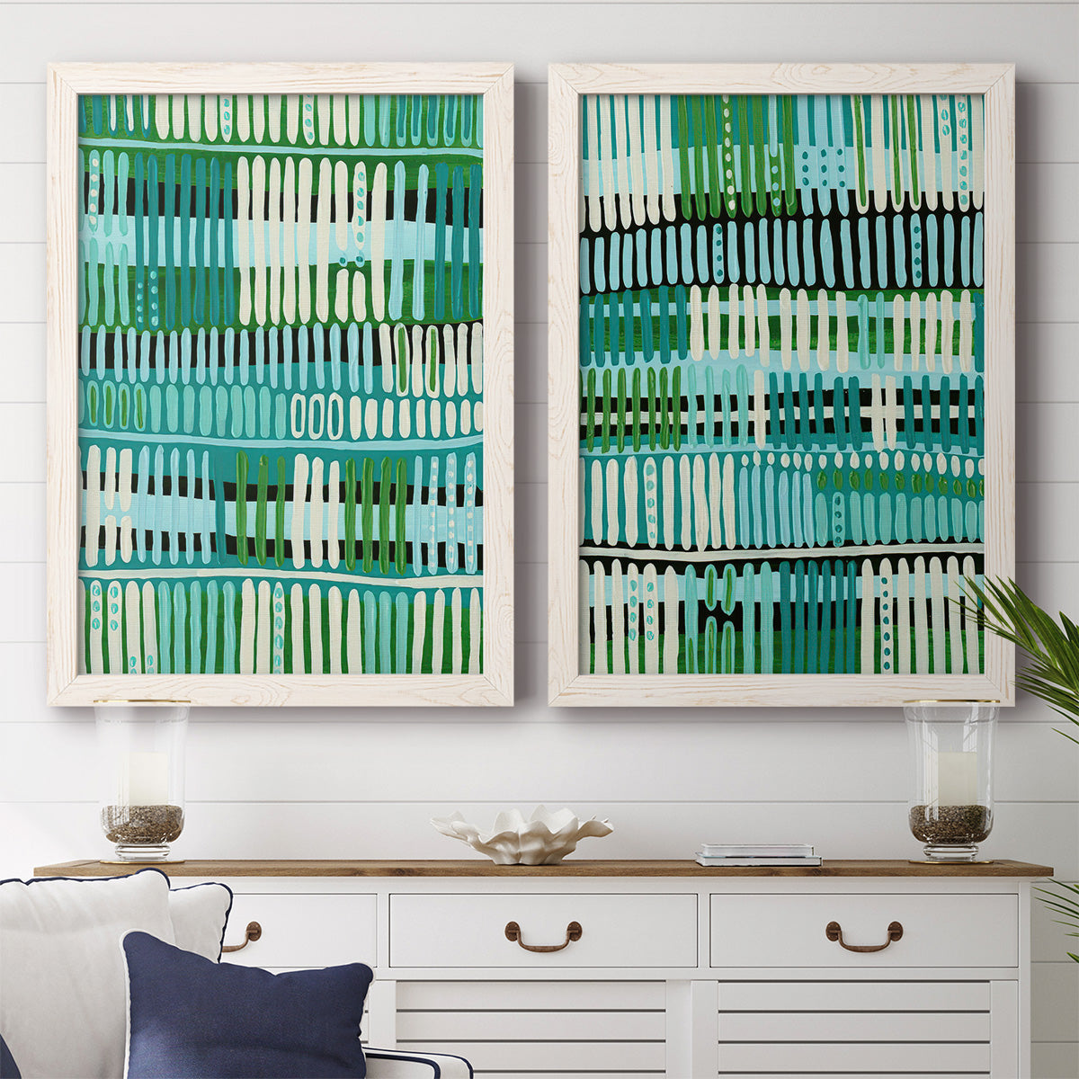Set of two white barnwood framed canvas prints depicting a coordinated art pair of dense rows of teal black and white linear marks rendered as graphic woven-pattern abstracts above a dining room sideboard.