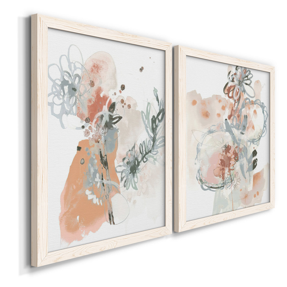 Angled view of a set of two white barnwood framed canvas prints featuring two abstract watercolor botanicals featuring loose blush gray and coral floral gestures.