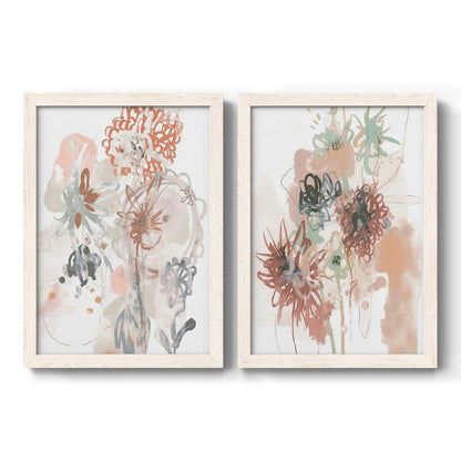 Set of two white barnwood framed canvas prints featuring two abstract watercolor botanicals featuring loose blush gray and coral floral gestures.