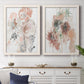Set of two white barnwood framed canvas prints depicting a coordinated art pair of loose blush gray and coral floral gestures rendered as abstract watercolor botanicals above a dining room sideboard.