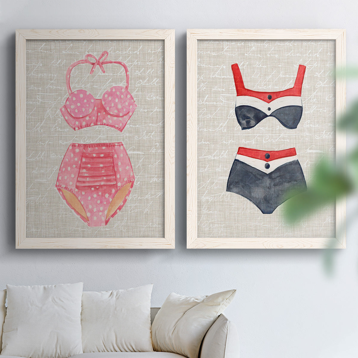 Set of two white barnwood framed canvas prints depicting striped and patterned bathing suits in red pink navy and white arranged across two complementary compositions above a sofa in a bright living space.