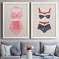 Set of two white barnwood framed canvas prints depicting paired vintage fashion illustrations with striped and patterned bathing suits in red pink navy and white above a sofa in a contemporary living room.