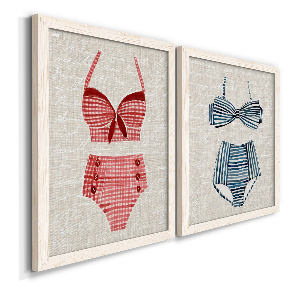 Angled view of a set of two white barnwood framed canvas prints featuring two vintage fashion illustrations featuring retro two-piece swimsuits displayed on textured linen grounds.