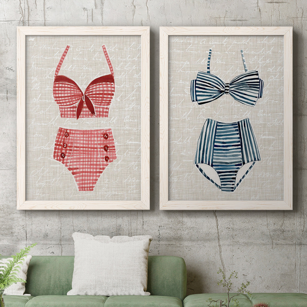 Set of two white barnwood framed canvas prints depicting a coordinated art pair of retro two-piece swimsuits displayed on textured linen grounds rendered as vintage fashion illustrations above a sofa in a modern living room.