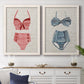Set of two white barnwood framed canvas prints depicting a coordinated art pair of retro two-piece swimsuits displayed on textured linen grounds rendered as vintage fashion illustrations above a dining room sideboard.