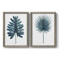 Set of two gray barnwood framed canvas prints featuring two modern botanical illustrations featuring large blue-green tropical leaves.