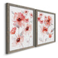 Angled view of a set of two gray barnwood framed canvas prints featuring two airy contemporary watercolor florals featuring loose coral pink blossoms on slender gray stems.